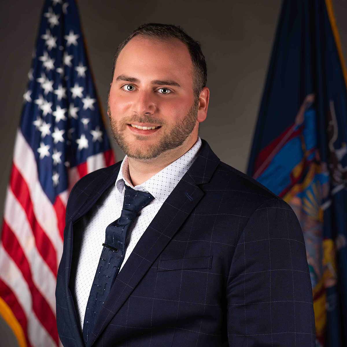 professional headshot of male employee wearing a suit