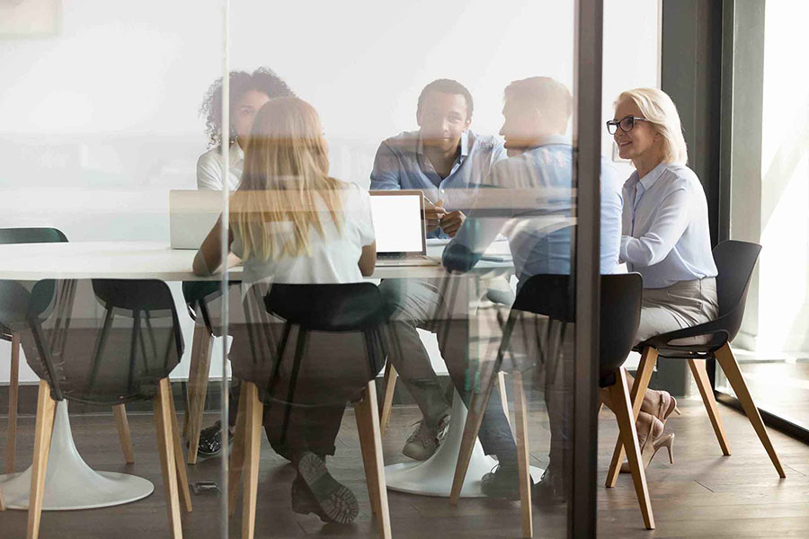 Office workers in a conference room having a collaborative working session